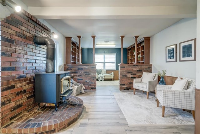 living room with a wood stove and wood finished floors