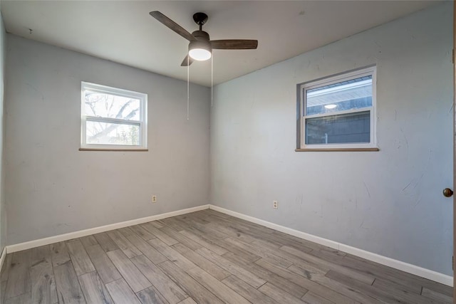 unfurnished room with a ceiling fan, baseboards, and wood finished floors