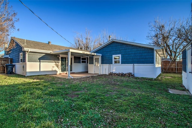 back of house featuring a patio area, a yard, and fence