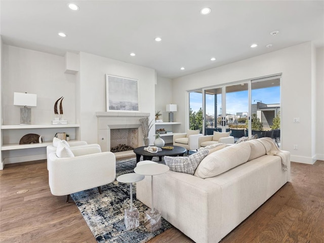 living area featuring a fireplace, wood finished floors, and recessed lighting