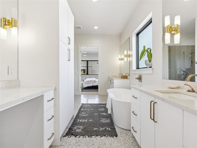 bathroom with recessed lighting, a soaking tub, connected bathroom, a shower stall, and vanity