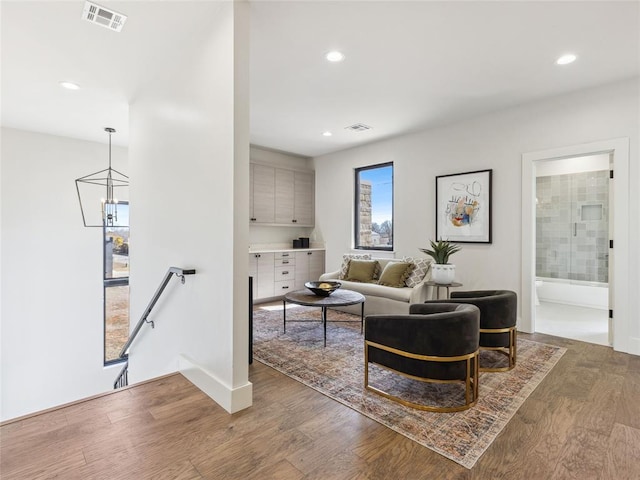 living room featuring wood finished floors, visible vents, and recessed lighting