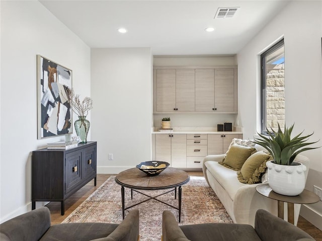 living area featuring recessed lighting, light wood-type flooring, visible vents, and baseboards