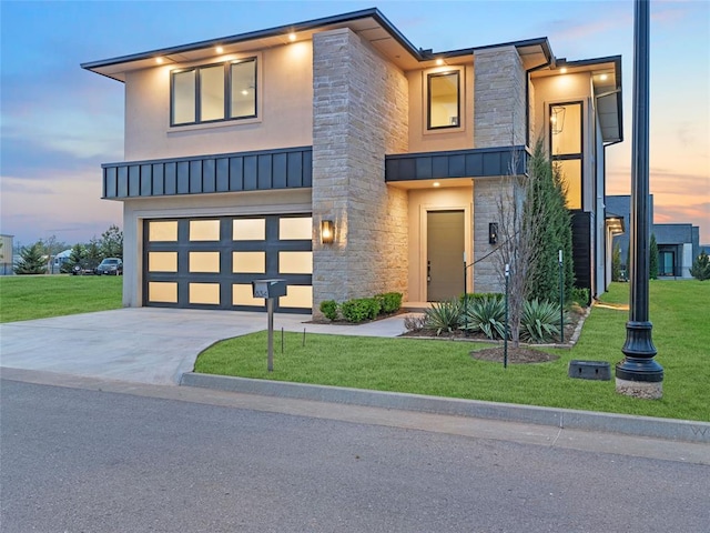 834 NW 72nd St, Oklahoma City, OK 73116 - contemporary house featuring stone siding, an attached garage, stucco siding, and a front yard