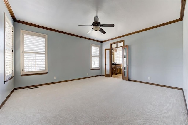 carpeted empty room featuring baseboards, visible vents, and ornamental molding