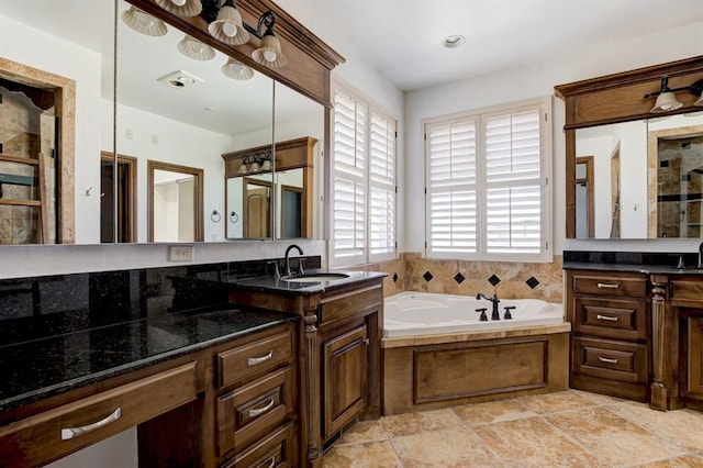 full bath with vanity and a bath