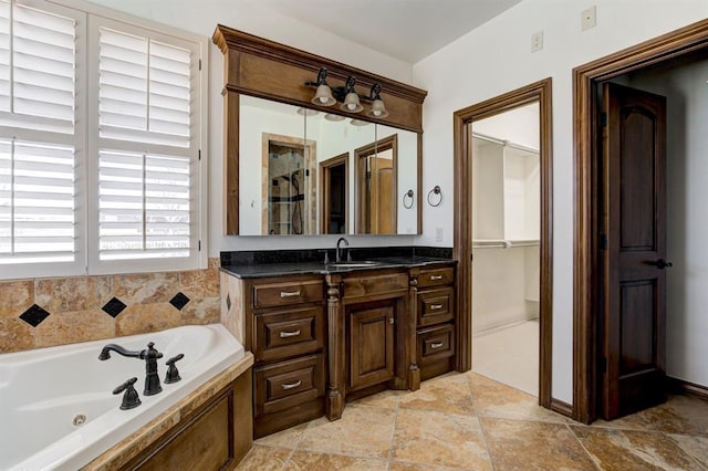 full bathroom featuring vanity and a whirlpool tub