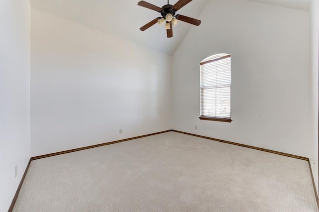 empty room featuring light carpet, high vaulted ceiling, a ceiling fan, and baseboards