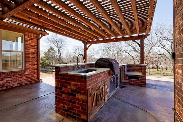 view of patio with a sink, area for grilling, and a pergola