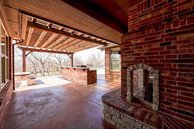 view of patio / terrace featuring an outdoor kitchen and a pergola