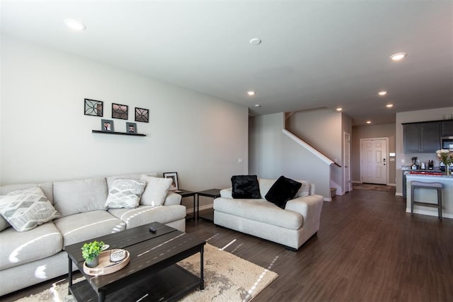 living area with dark wood-style floors, stairs, baseboards, and recessed lighting