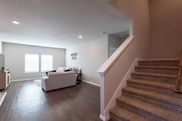 living area with dark wood-style floors, recessed lighting, baseboards, and stairs