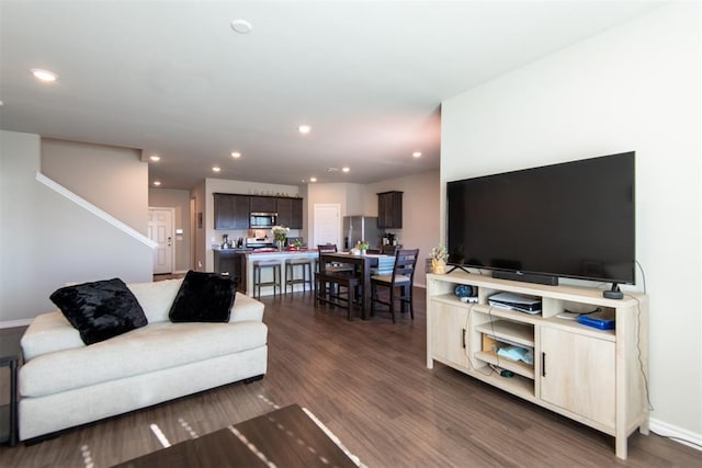 living area featuring baseboards, dark wood-style flooring, and recessed lighting