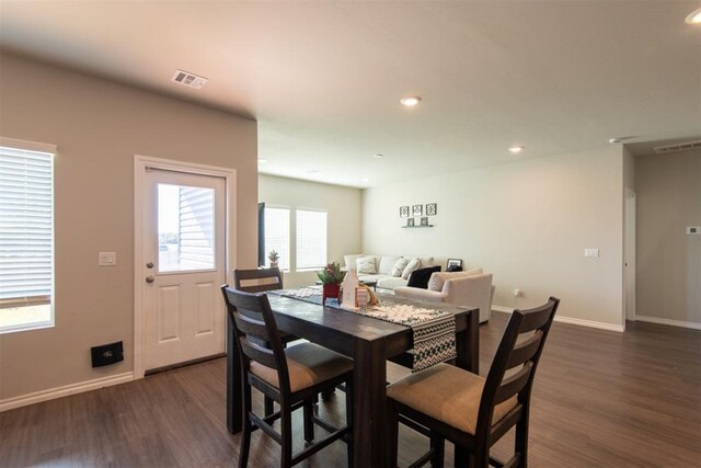 dining room featuring dark wood-type flooring, recessed lighting, visible vents, and baseboards