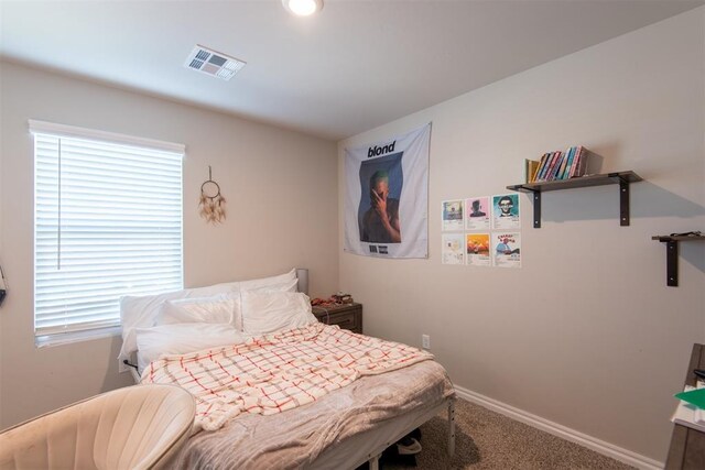 bedroom featuring baseboards, visible vents, and carpet flooring