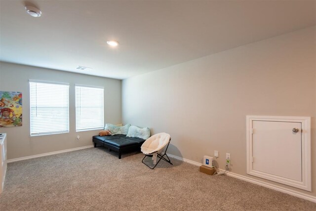 unfurnished room featuring baseboards, visible vents, and light colored carpet