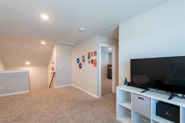 interior space with attic access, light colored carpet, visible vents, and baseboards