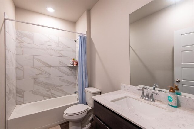 full bathroom featuring toilet, shower / bath combo, and vanity