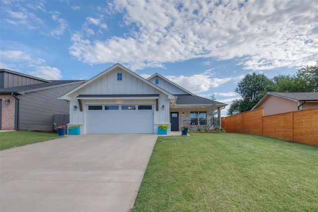 view of front of property with board and batten siding, a front yard, and a garage