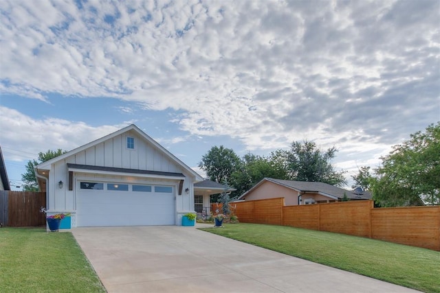 view of front of house featuring concrete driveway, an attached garage, board and batten siding, fence, and a front lawn