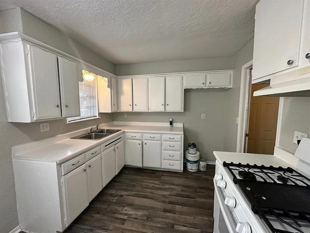 kitchen featuring light countertops, white range with gas stovetop, and white cabinets