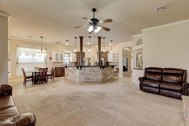 living room with light carpet, visible vents, arched walkways, crown molding, and ceiling fan with notable chandelier