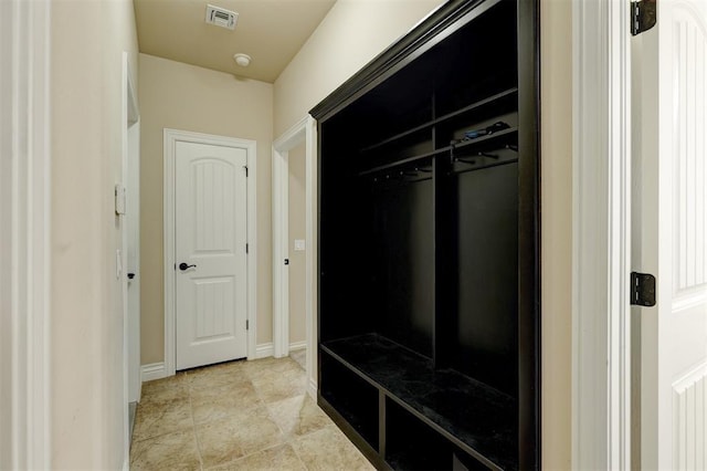 mudroom featuring light tile patterned flooring, visible vents, and baseboards