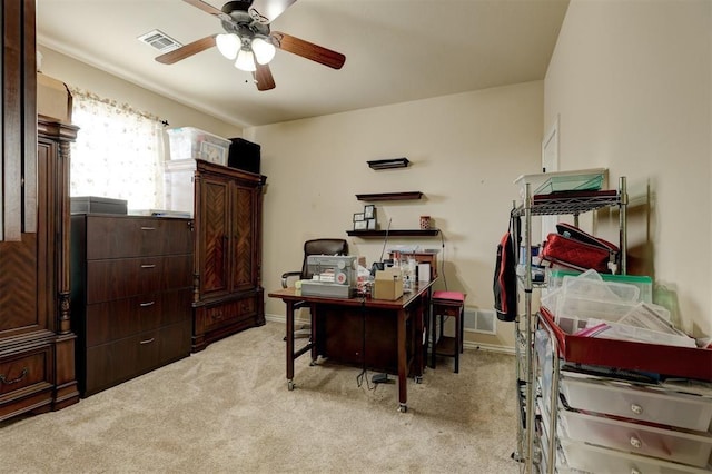 home office with light carpet, ceiling fan, visible vents, and baseboards