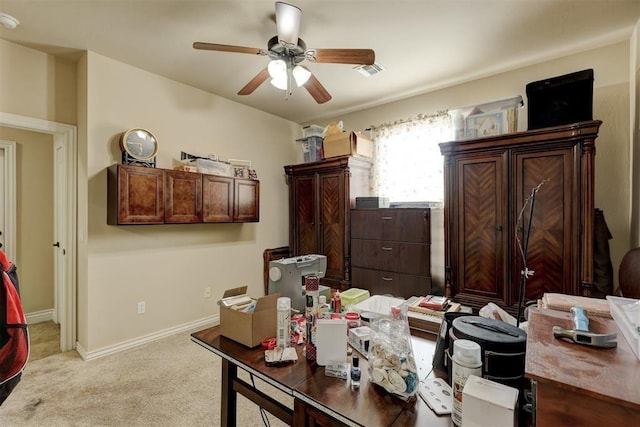 office area featuring light carpet, ceiling fan, visible vents, and baseboards