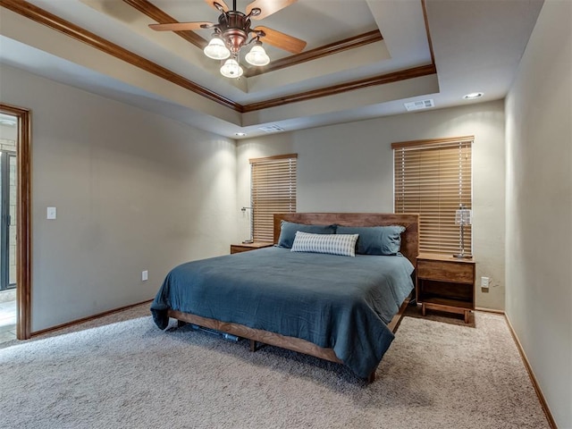 bedroom featuring carpet flooring, visible vents, baseboards, ornamental molding, and a raised ceiling