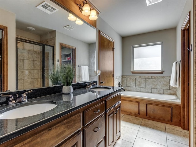 full bathroom featuring a garden tub, tile patterned flooring, a sink, and visible vents