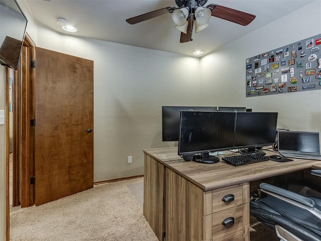 office area with light carpet, ceiling fan, and baseboards