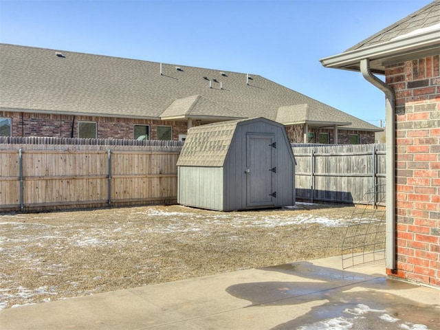 view of yard with an outbuilding, a storage unit, a patio area, and a fenced backyard