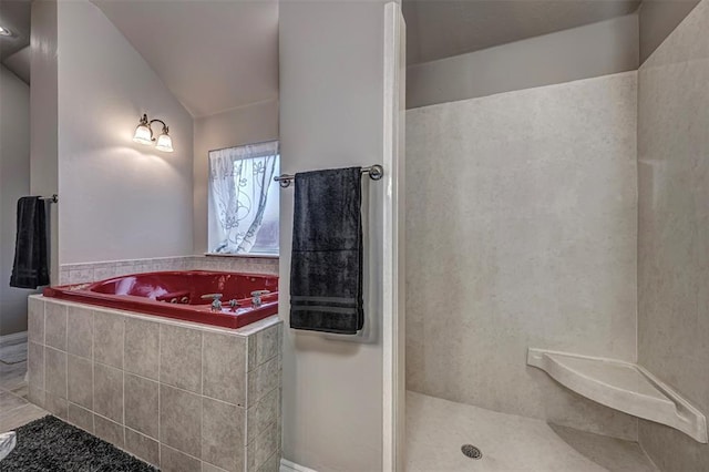 full bathroom featuring lofted ceiling, a walk in shower, and a bath