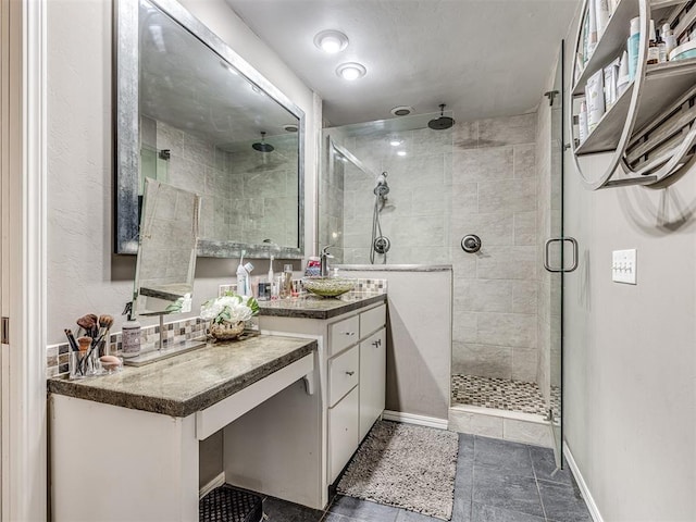 full bathroom with a shower stall, vanity, and baseboards