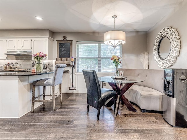 dining area featuring dark wood finished floors and recessed lighting