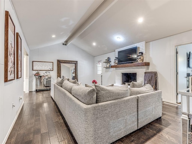 living area featuring lofted ceiling with beams, a brick fireplace, dark wood-style floors, and visible vents