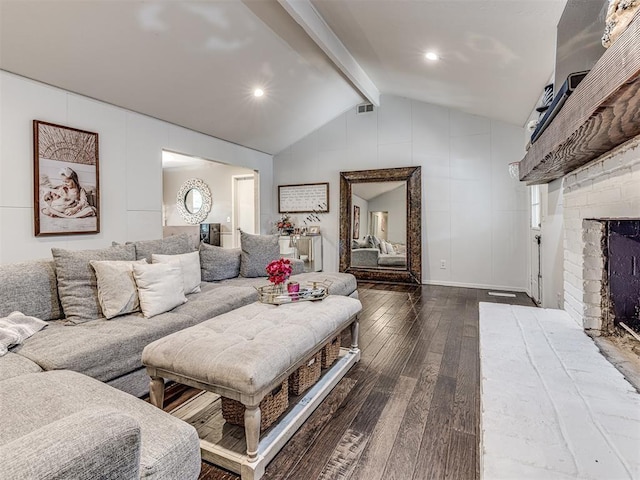 living area featuring a brick fireplace, visible vents, vaulted ceiling with beams, and wood finished floors