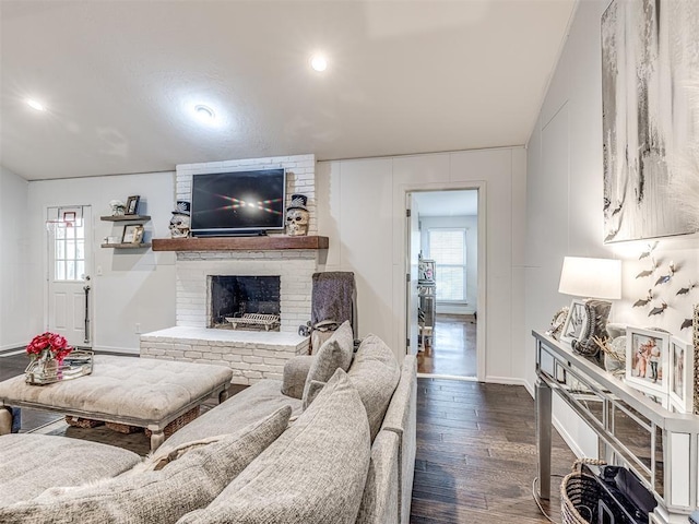 living room featuring dark wood-style floors, a fireplace, and recessed lighting