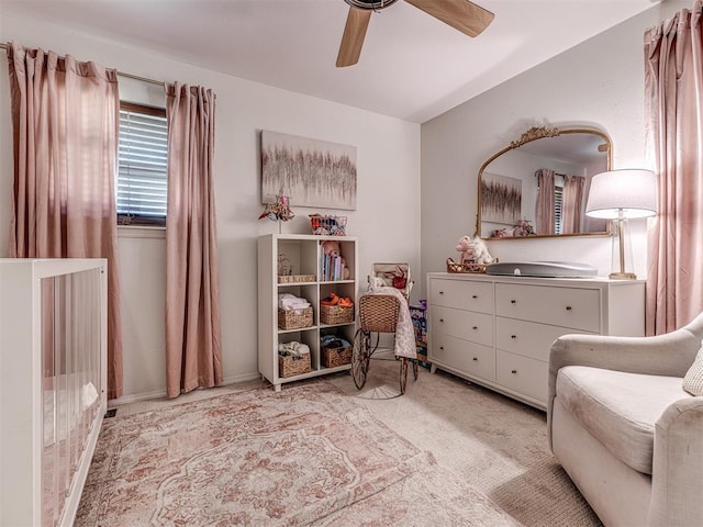 sitting room with ceiling fan and light colored carpet