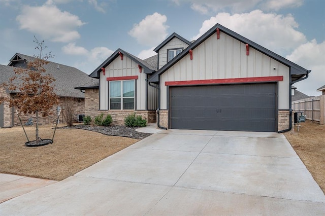 craftsman inspired home with driveway, a shingled roof, an attached garage, fence, and board and batten siding