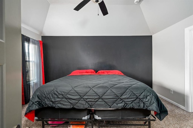 bedroom featuring carpet floors, vaulted ceiling, baseboards, and a ceiling fan