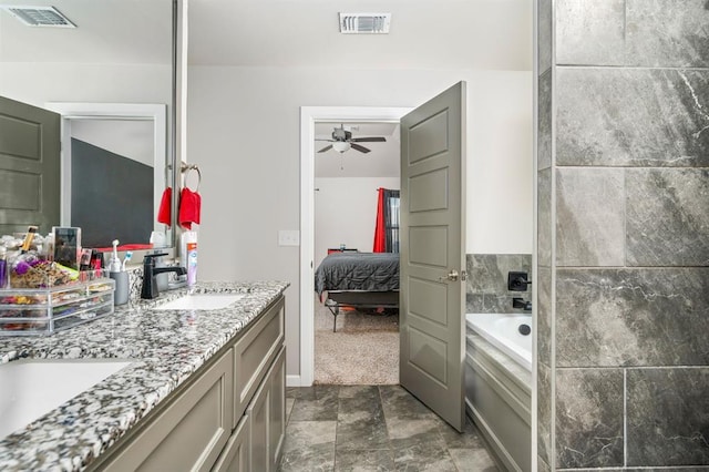 ensuite bathroom with a bath, ensuite bath, visible vents, and a sink