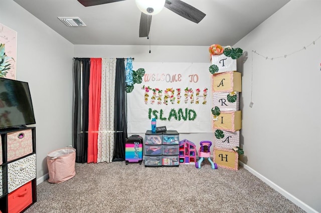 rec room with carpet, visible vents, and baseboards