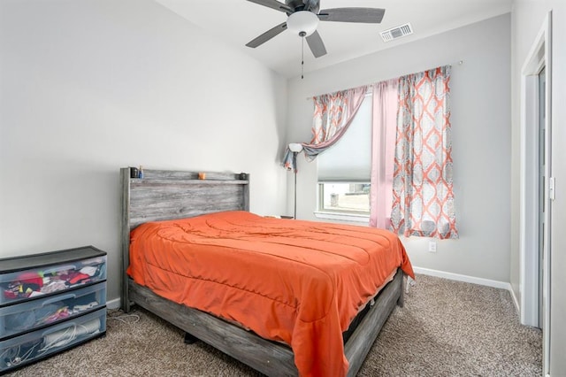 carpeted bedroom featuring a ceiling fan, visible vents, and baseboards