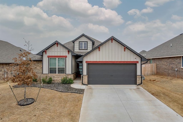 craftsman-style home with roof with shingles, concrete driveway, an attached garage, board and batten siding, and a front lawn