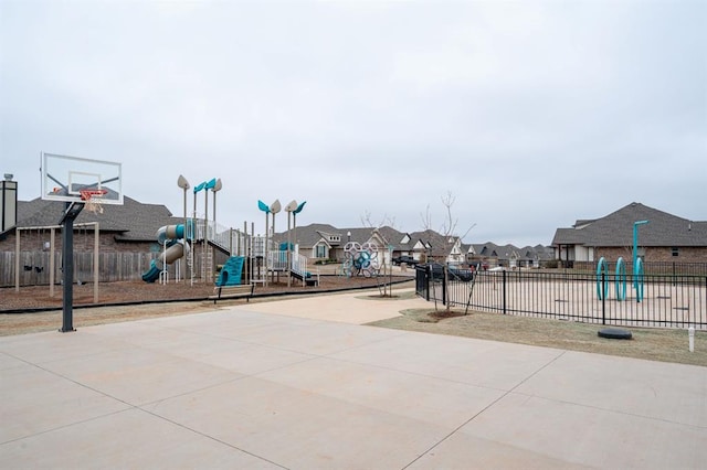 exterior space with playground community, fence, a residential view, and community basketball court