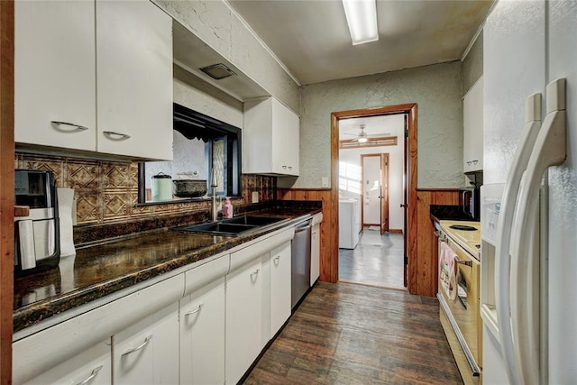 kitchen with electric stove, white cabinets, a sink, wainscoting, and white fridge with ice dispenser