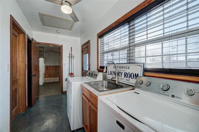 washroom with washer and dryer, cabinet space, a sink, and visible vents