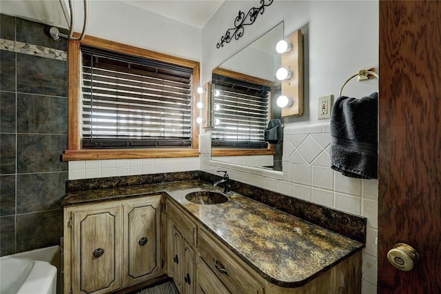 bathroom with a bathing tub, tile walls, and vanity